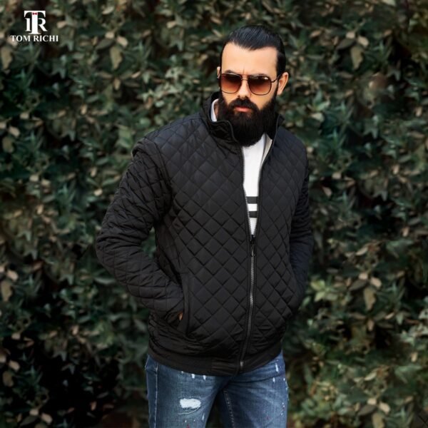 Black Quilted Jacket: "Men's black quilted jacket styled with casual ripped jeans.